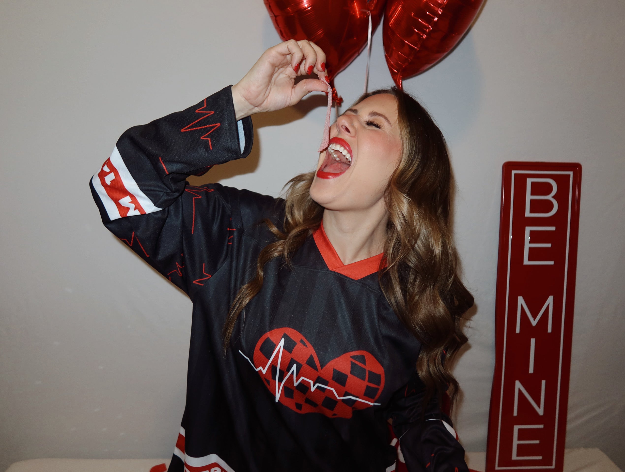 Rave Model is wearing her rave hockey jersey eating Valentine's candy.