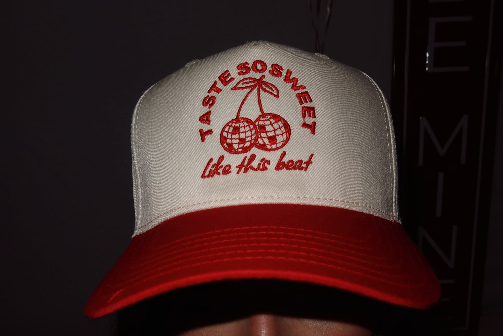 Person wearing Sweet Beat disco cherries cream and red hat. 