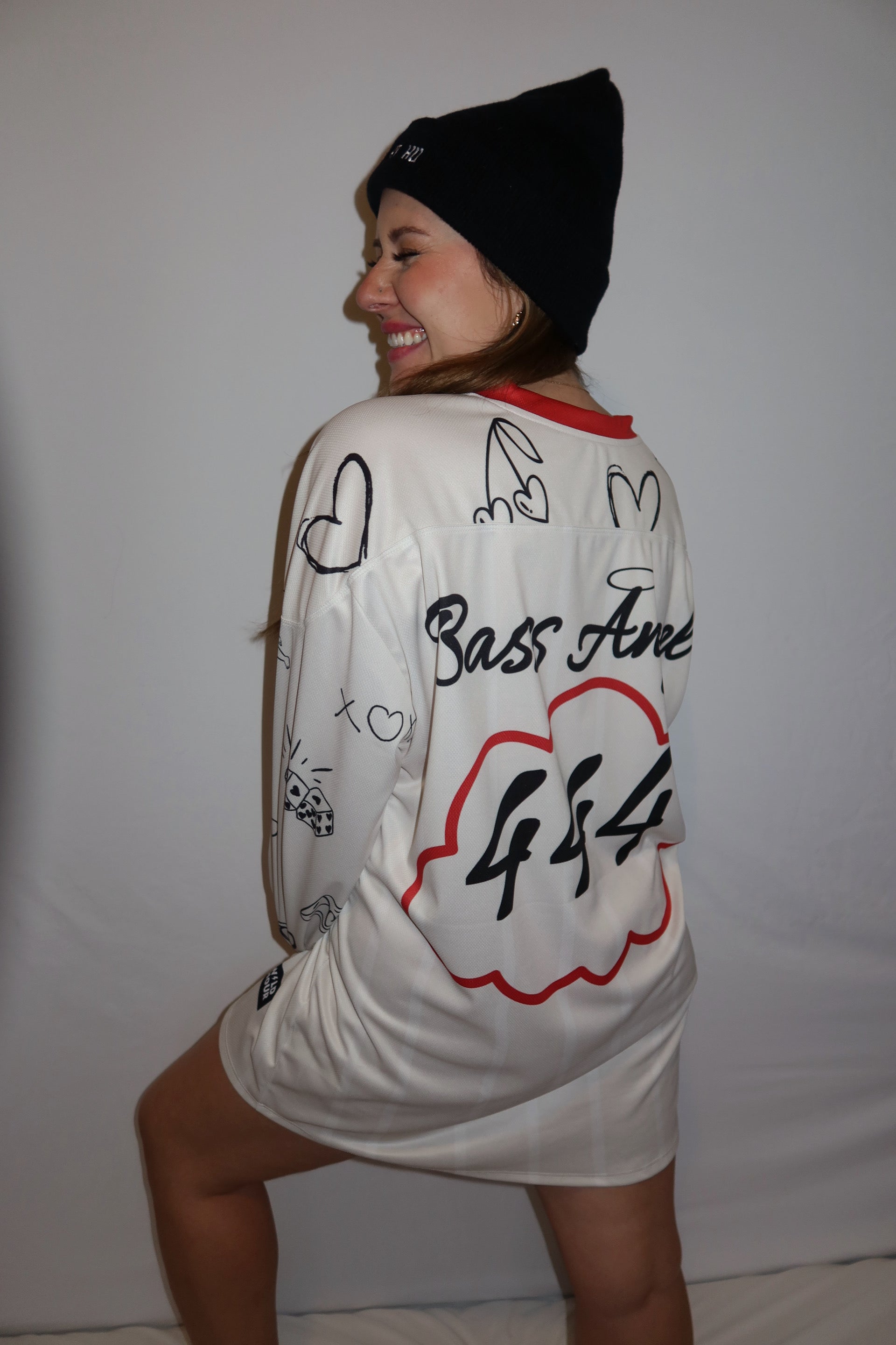 Person smiling hard and showing the back of the Bass Angel jersey.